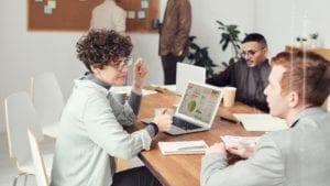 Three people resolving workplace conflict