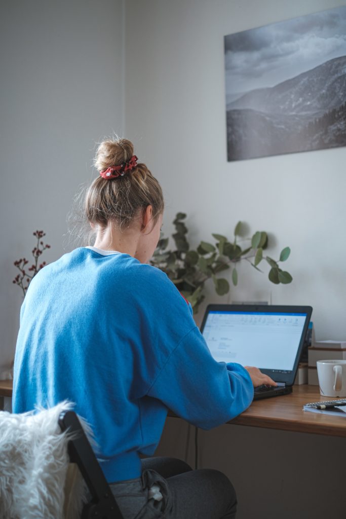 Woman on a laptop working remotely as part on an effective remote team