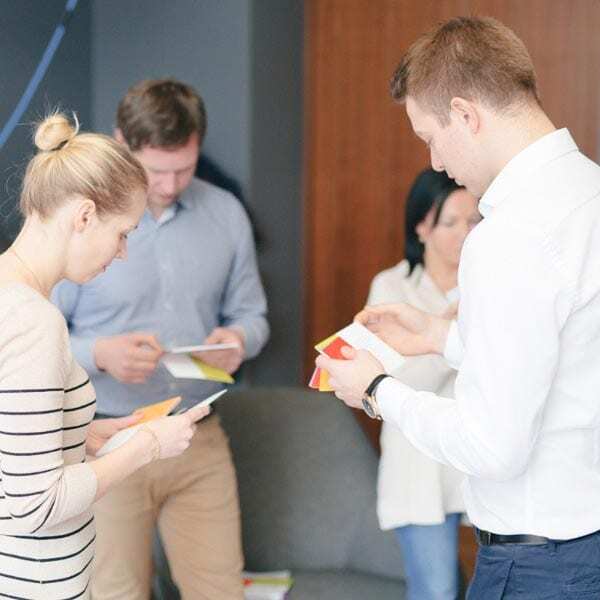 Participants looking at Spark cards on a team development workshop