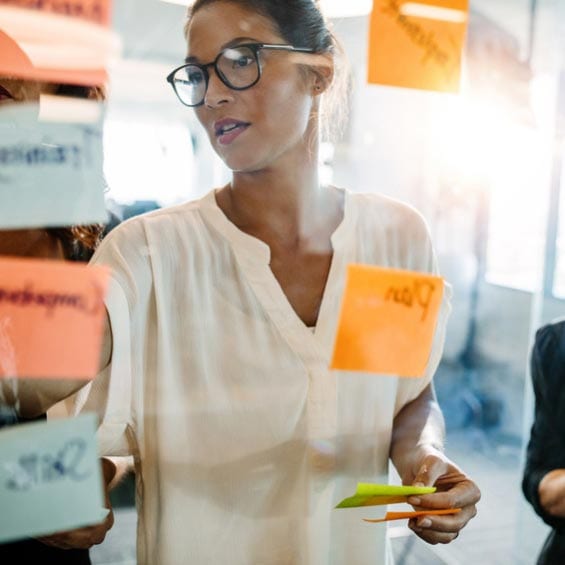 Woman planning a development session with a sticky notes